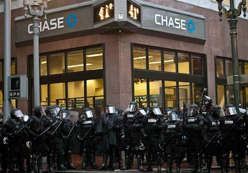 Police in riot gear protecting a bank